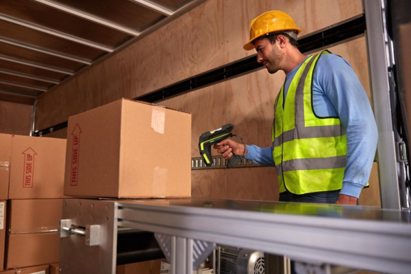 Warehouse worker uses RFID scan gun on inbound inventory.