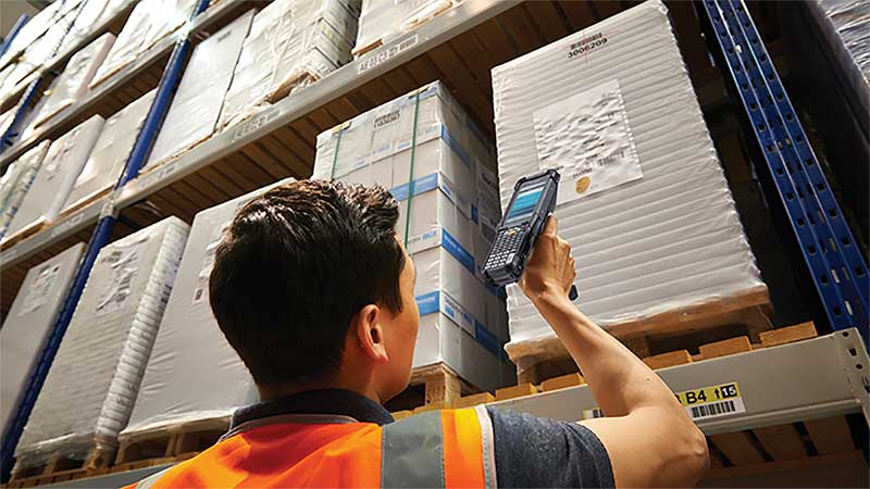 warehouse worker performing inventory management with scan gun