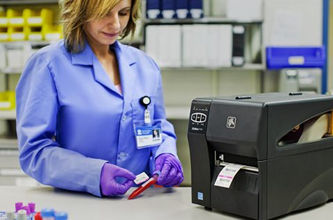 Lab tech labeling a blood sample