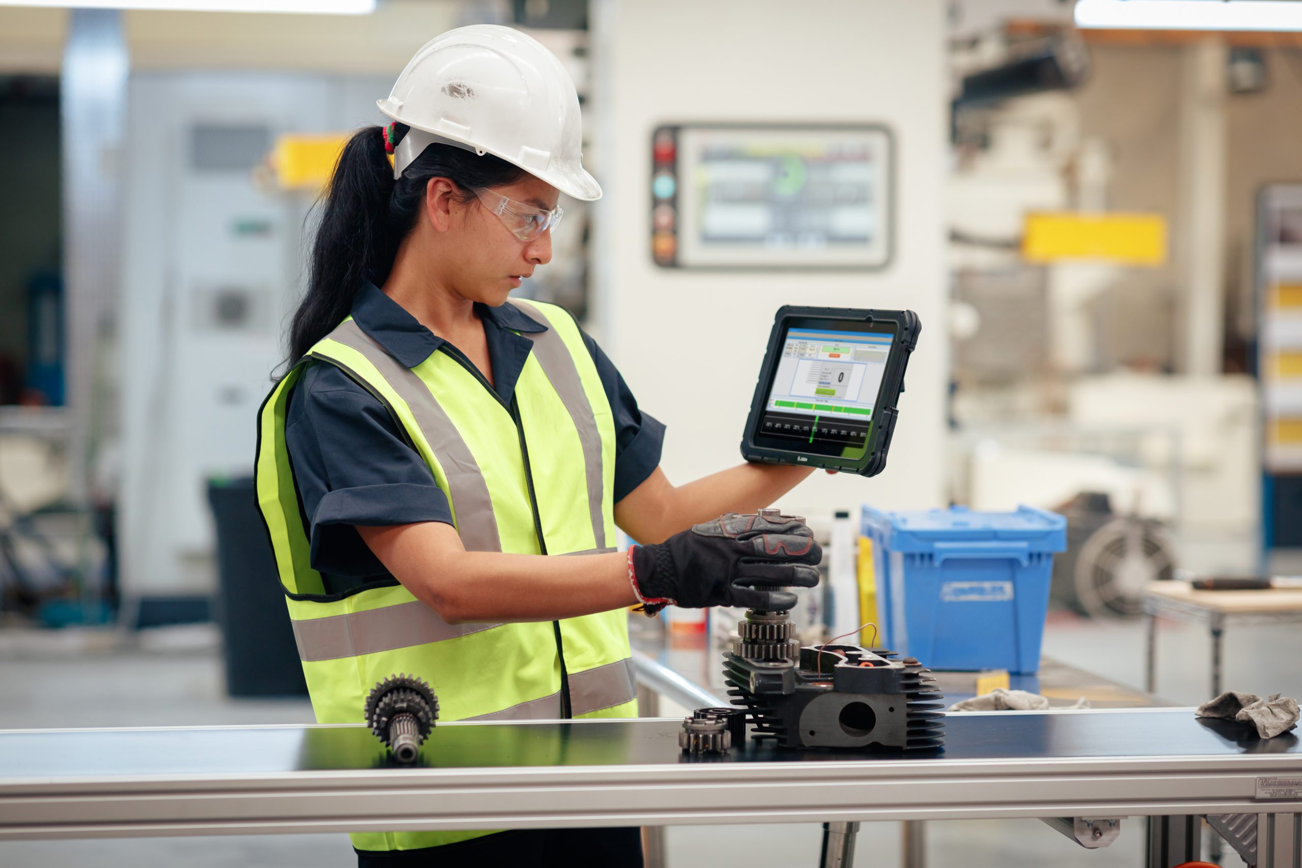 woman using zebra tablet on assembly line