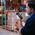 worker uses mobile computer workfoce communication in warehouse