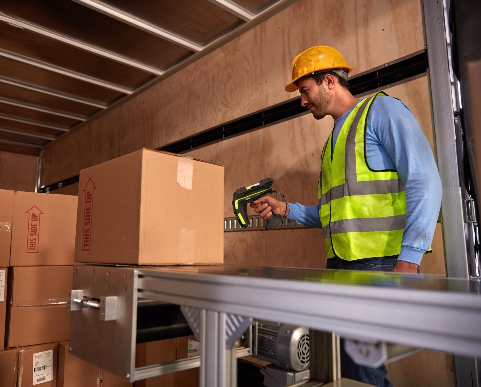 warehouse worker uses rfd90 reader to validate inbound RFID tags coming off of a truck.
