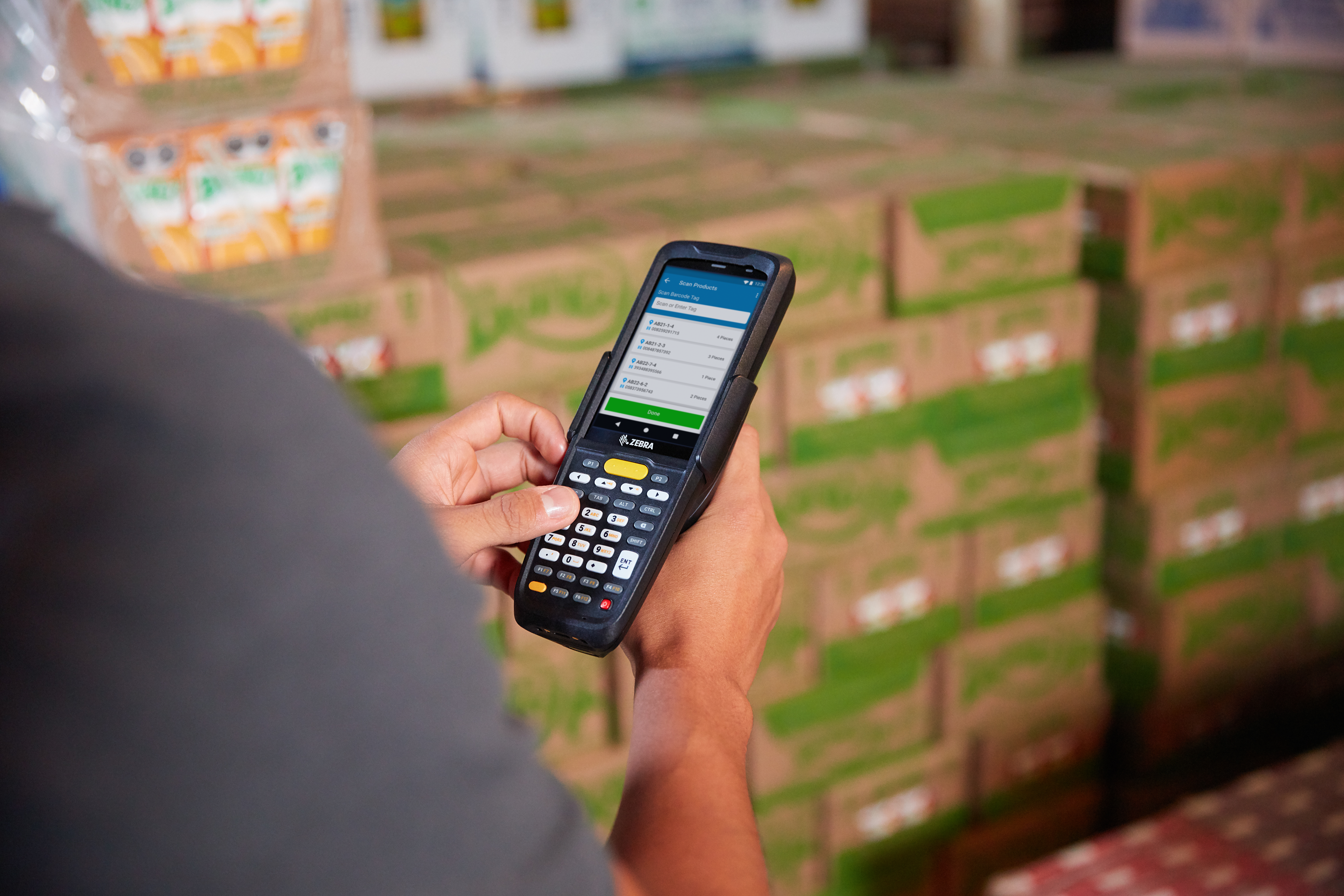 Worker using MC2200 warehouse scan gun.